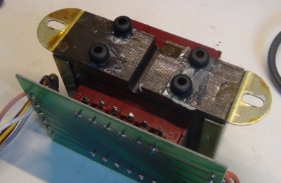 rubber grommets glued underneath the transformer to reduce acoustic buzz